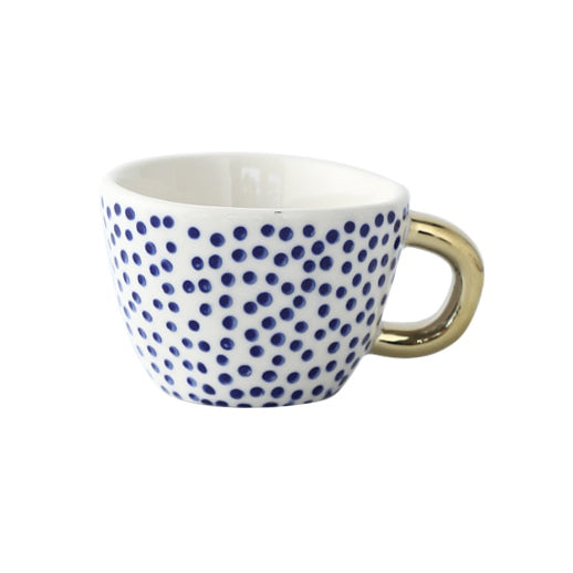 Mugg med abstrakt geometriskt mönster och guldhandtag