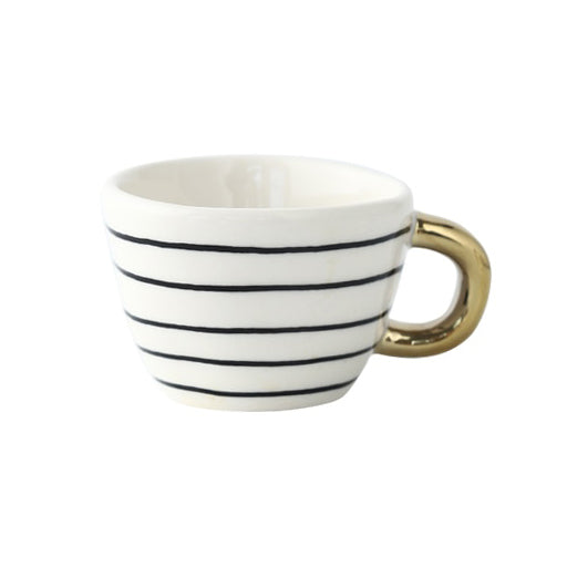 Mugg med abstrakt geometriskt mönster och guldhandtag